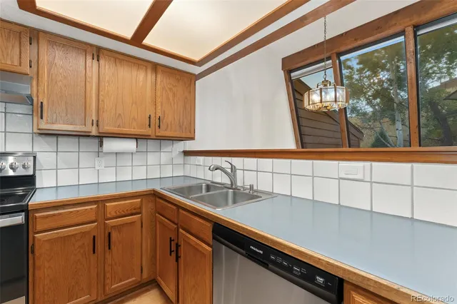 a kitchen with a refrigerator and a stove