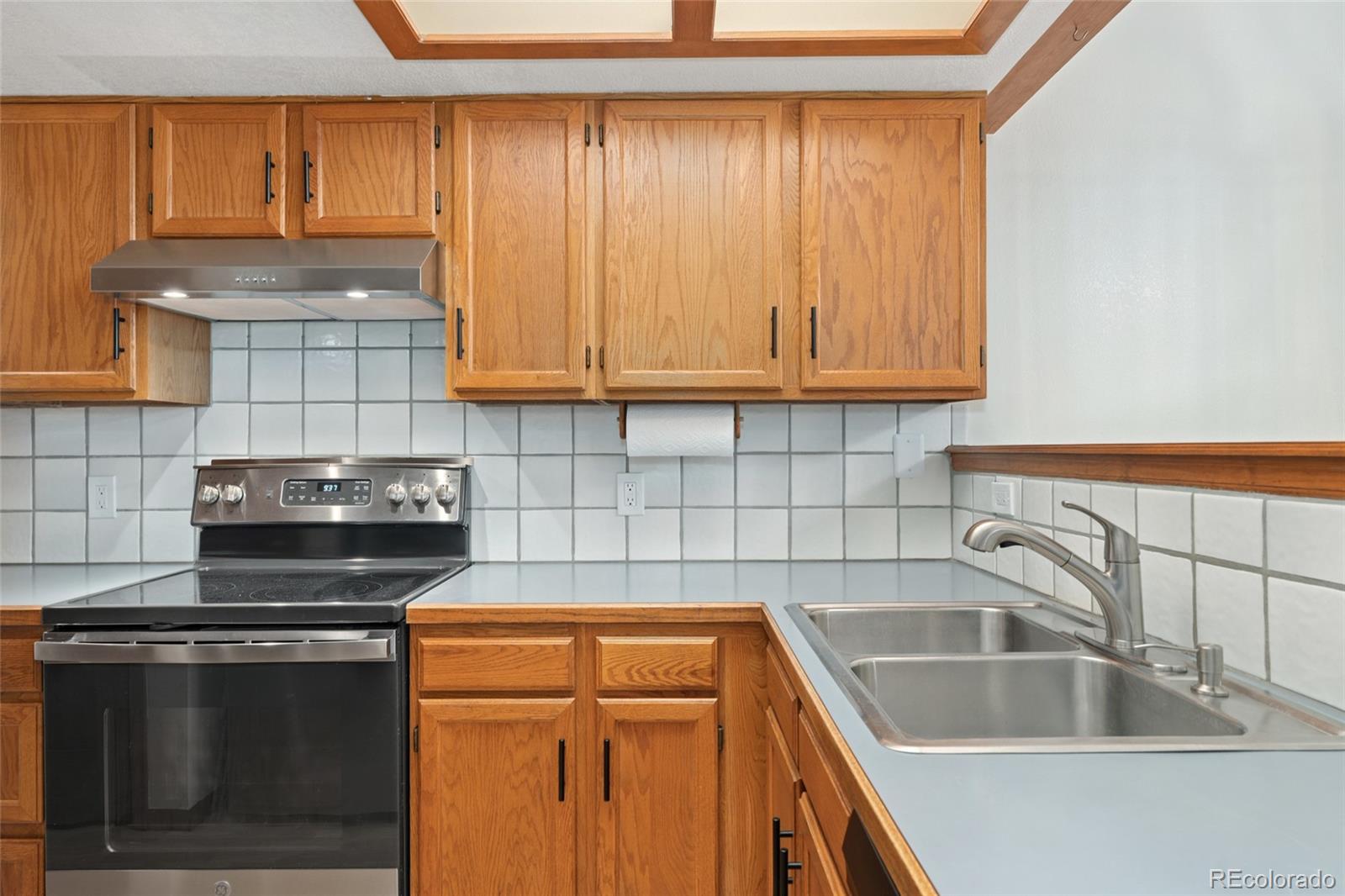 92 Ward Court Lakewood, CO 80228 - Photo 13 of 37 a kitchen with granite countertop a sink a stove and cabinets