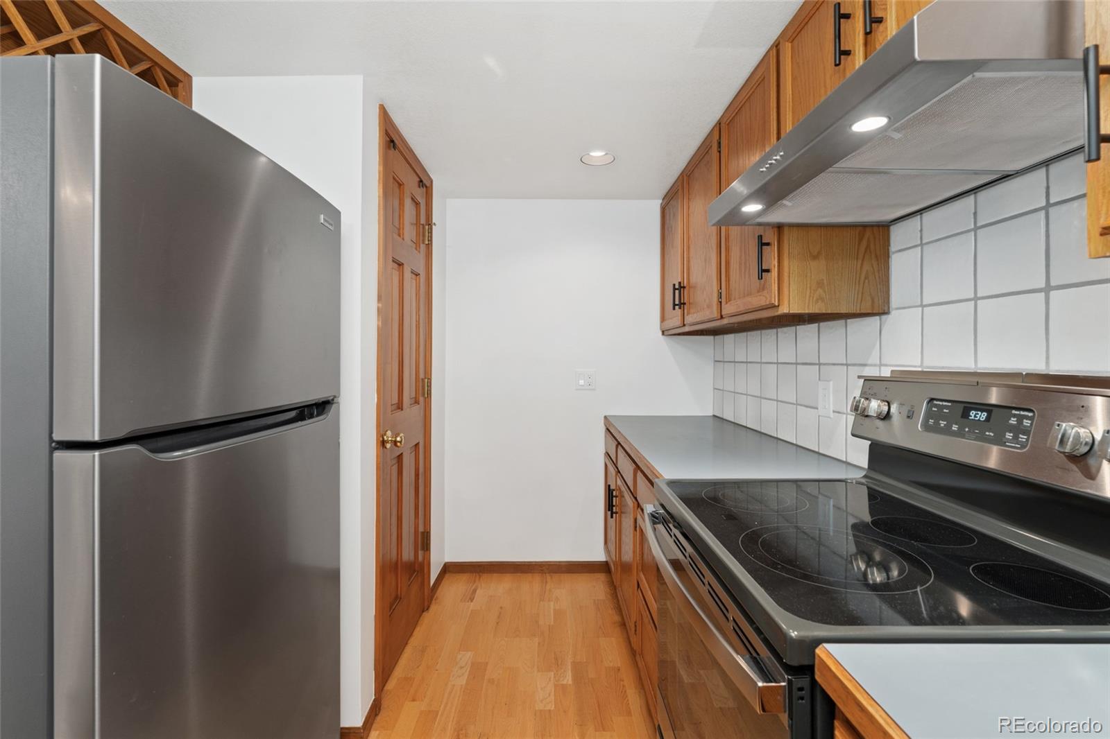 92 Ward Court Lakewood, CO 80228 - Photo 14 of 37 a kitchen with a refrigerator and a stove