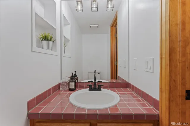 a view of a hallway with wooden floor and a potted plant
