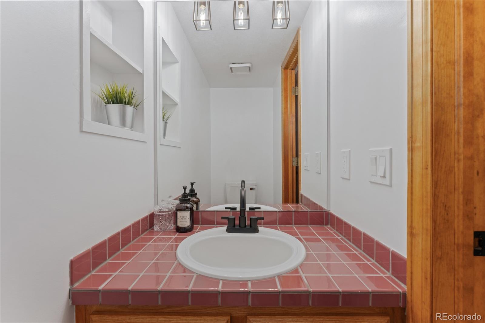 92 Ward Court Lakewood, CO 80228 - Photo 16 of 37 a bathroom with a sink and a mirror