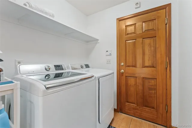 a bedroom with a bed and glass walk in closet