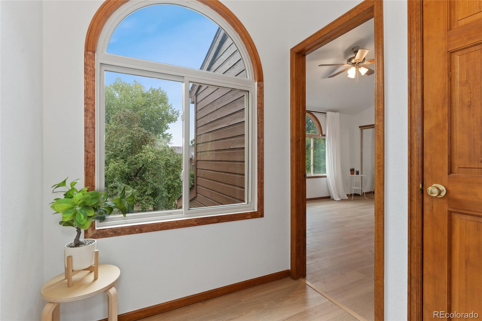 92 Ward Court Lakewood, CO 80228 - Photo 18 of 37 a view of a hallway with wooden floor and a potted plant