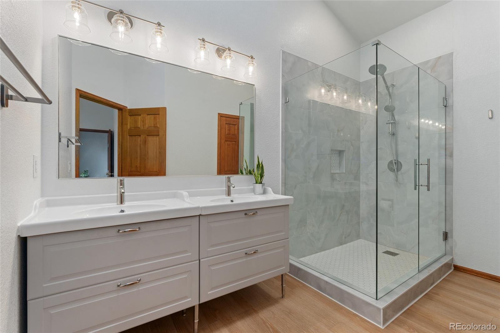 92 Ward Court Lakewood, CO 80228 - Photo 22 of 37 a bathroom with a shower sink and mirror