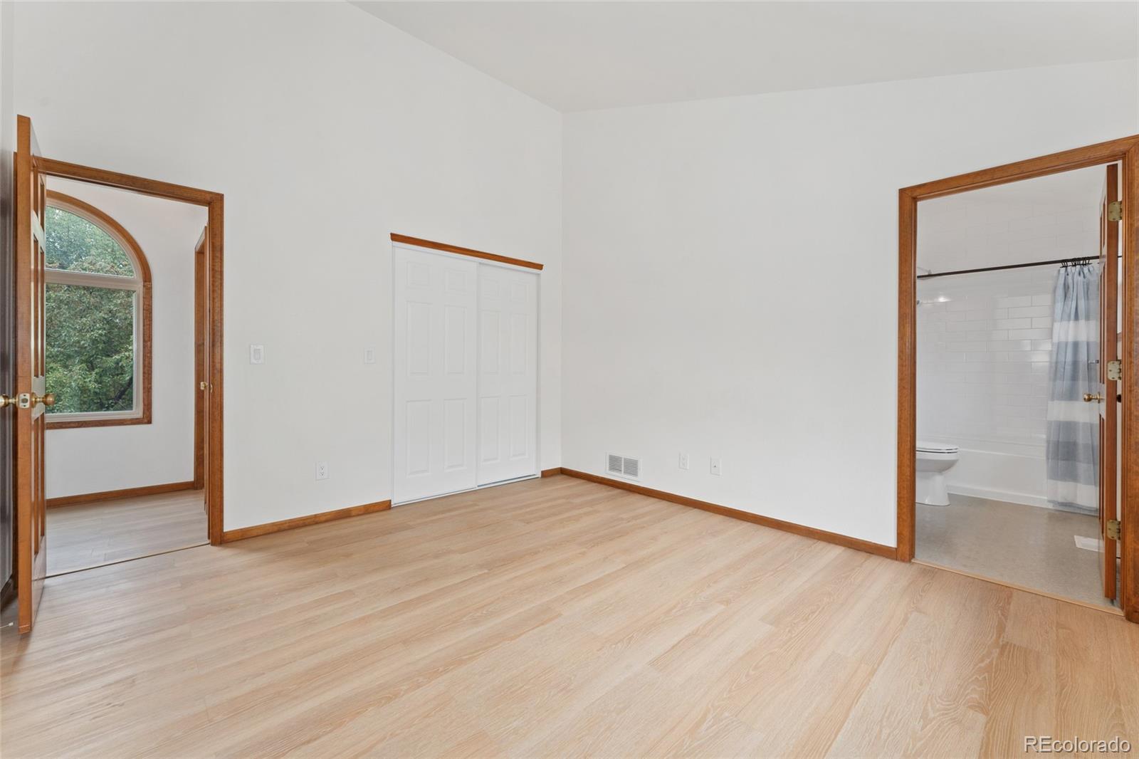 92 Ward Court Lakewood, CO 80228 - Photo 25 of 37 a view of an empty room with wooden floor and a window