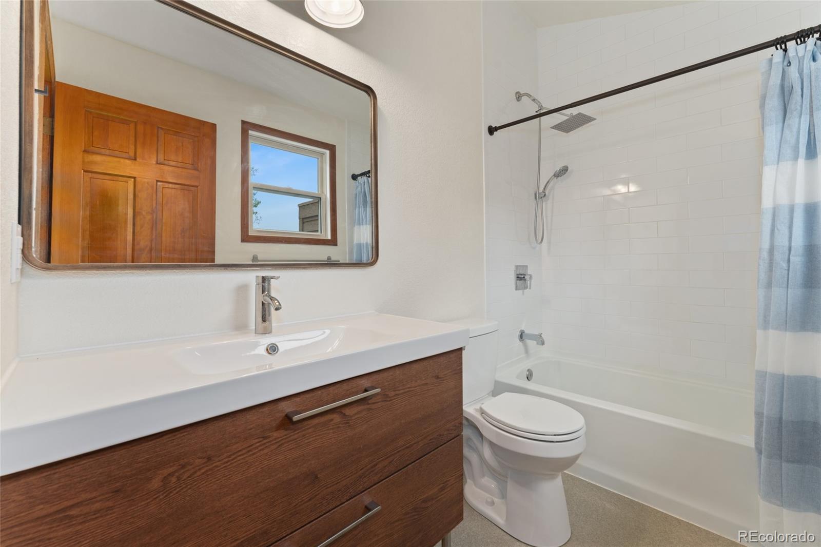 92 Ward Court Lakewood, CO 80228 - Photo 26 of 37 a bathroom with a sink a toilet and shower