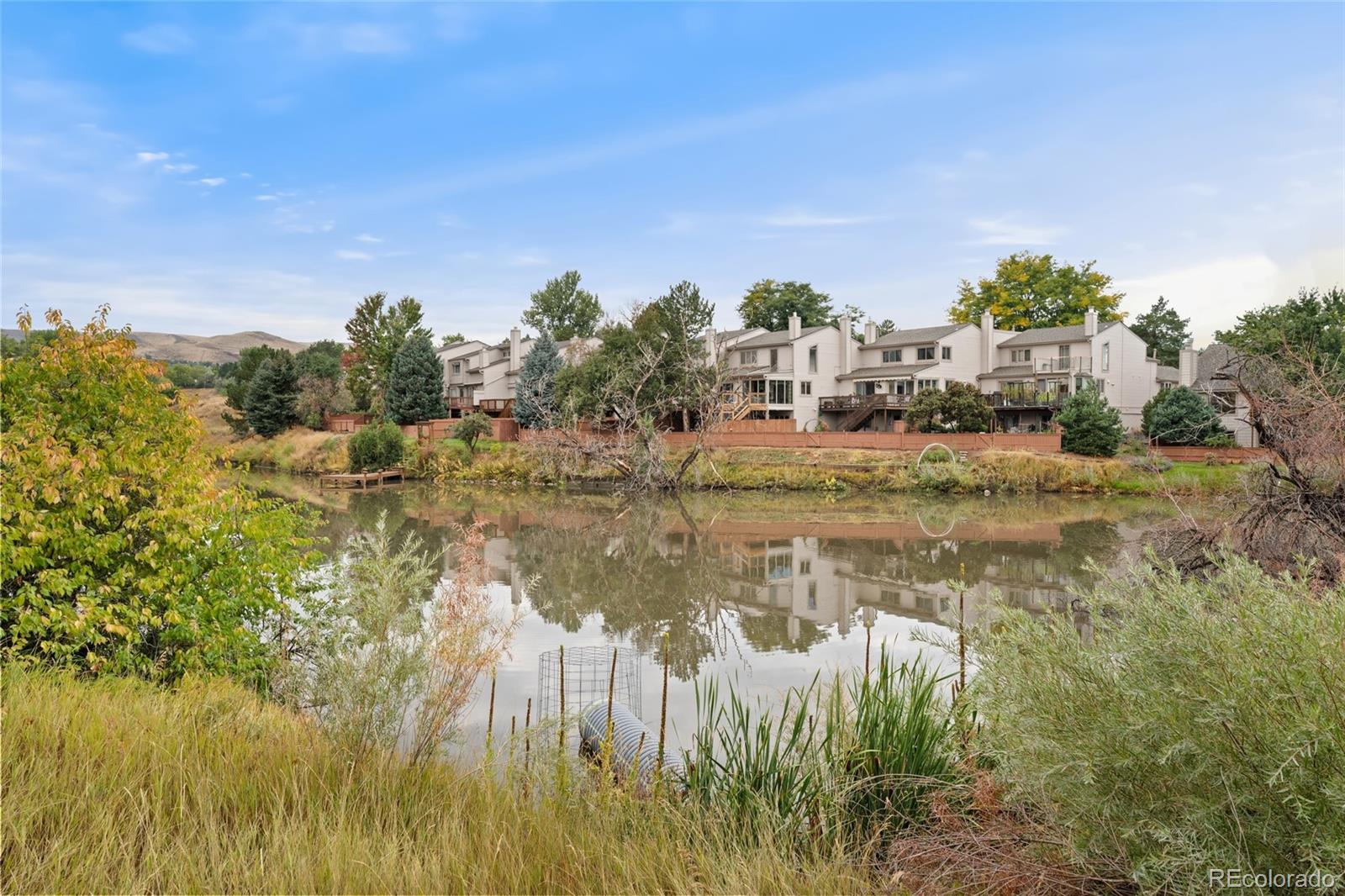 92 Ward Court Lakewood, CO 80228 - Photo 30 of 37 a view of a lake with houses in the back