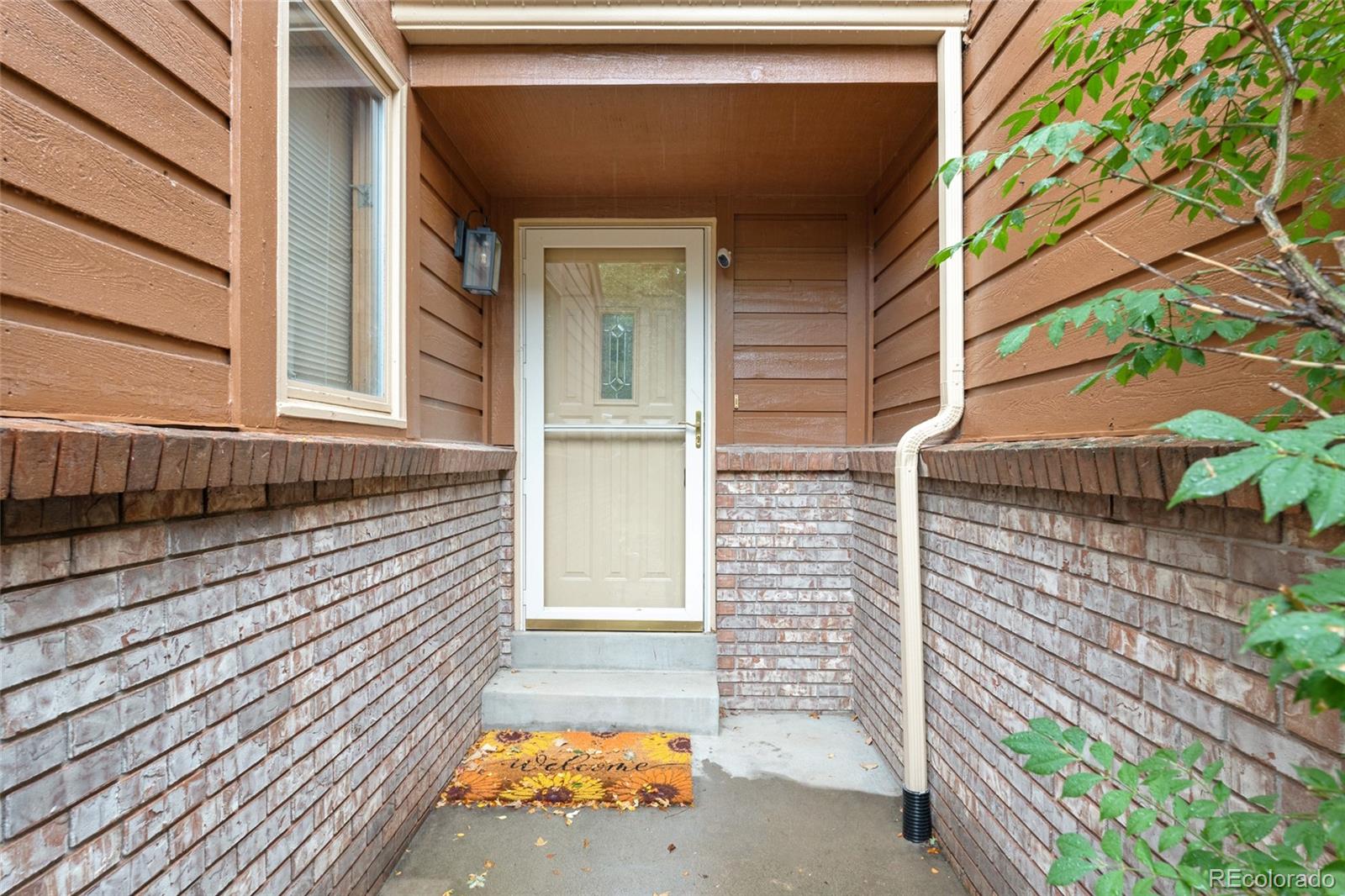 92 Ward Court Lakewood, CO 80228 - Photo 4 of 37 a backyard of a house with seating space