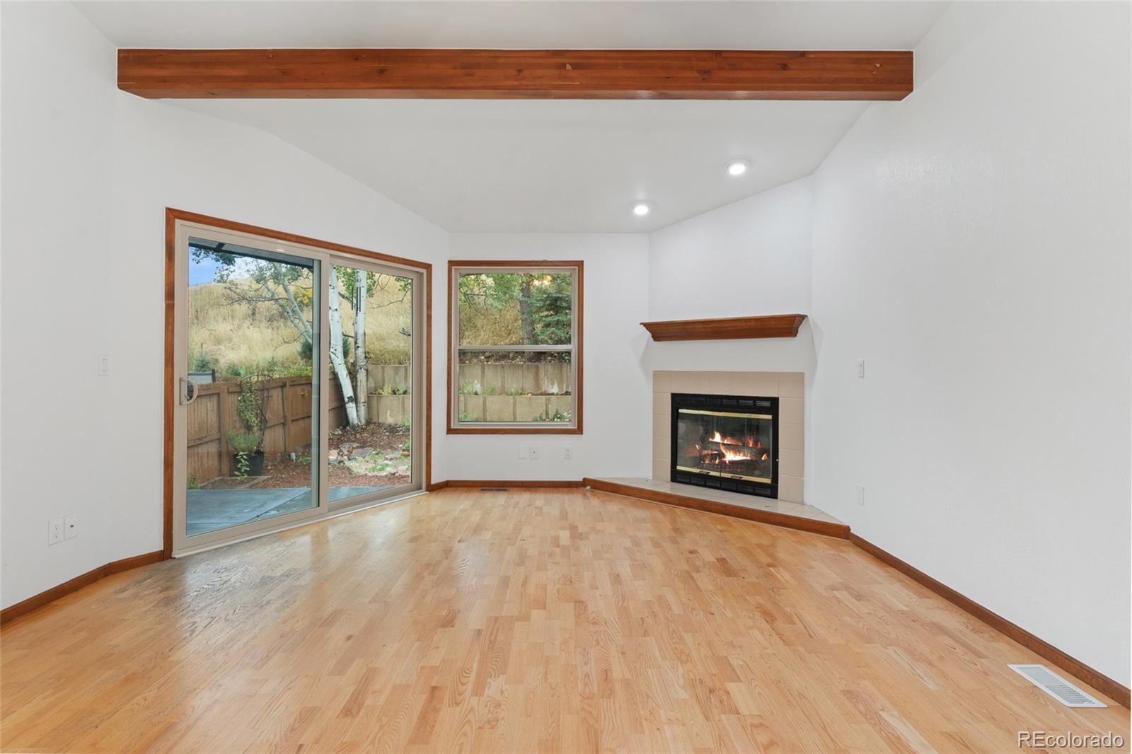 92 Ward Court Lakewood, CO 80228 - Photo 7 of 37 wooden floor fireplace and natural light in room
