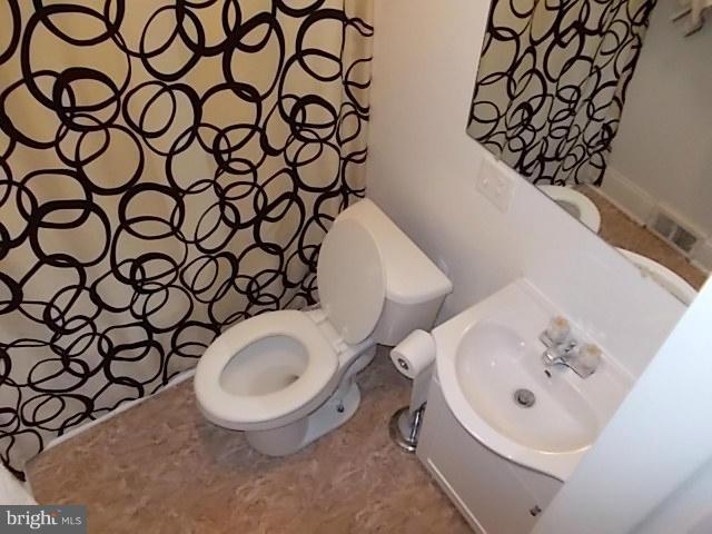 1203 Edgewood Road Edgewood, MD 21040 - Photo 15 of 27 a bathroom with a sink and a mirror