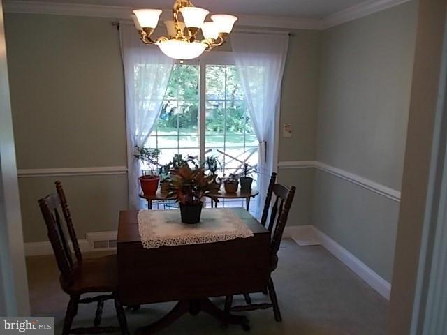 1203 Edgewood Road Edgewood, MD 21040 - Photo 10 of 27 a dining room with furniture a large window and wooden floor