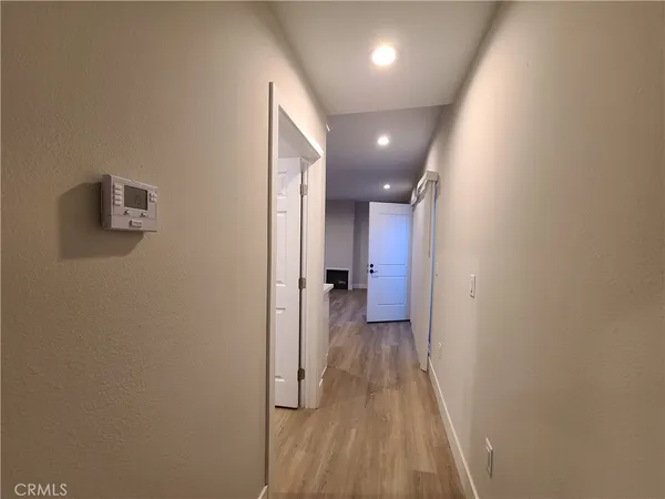 a view of a hallway with wooden floor