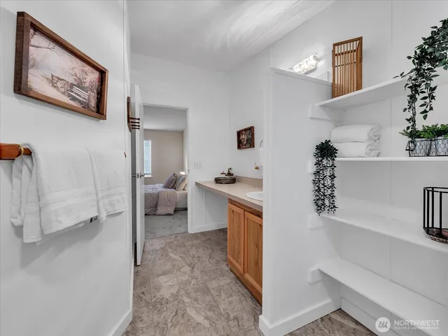 a hall way with furniture and a window