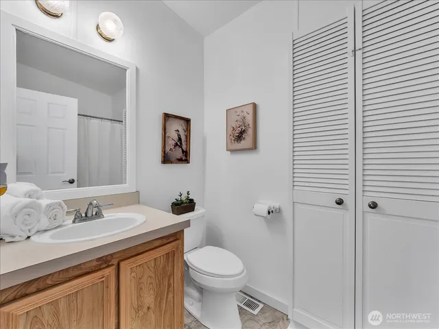 a bathroom with a sink toilet and vanity