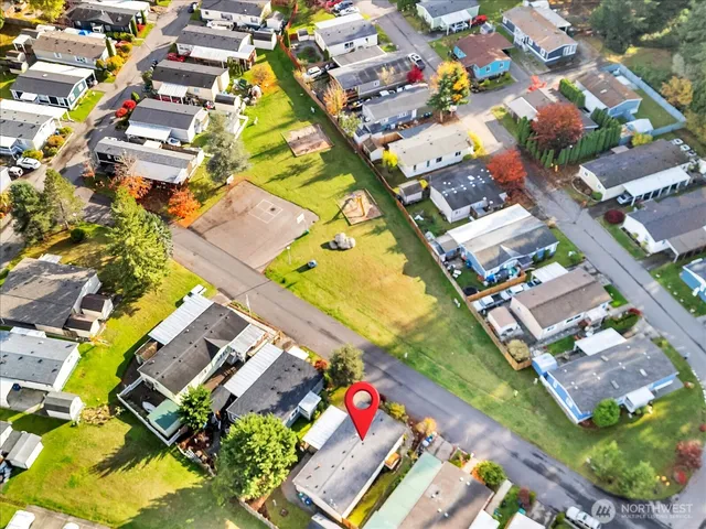 an aerial view of a house with a yard and trees