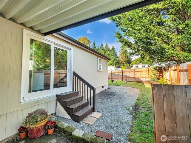 a view of a porch with furniture and a yard