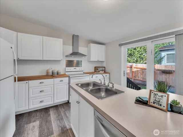 a kitchen that has cabinets stove and a sink
