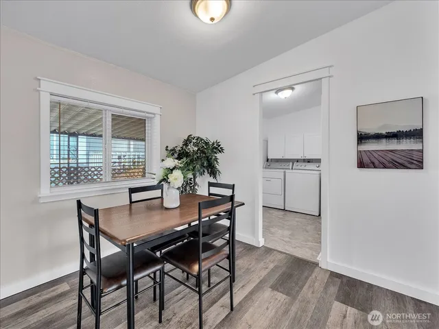 a view of a dining room with furniture and window