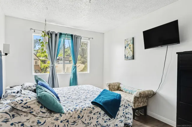 a bedroom with a bed and a dresser