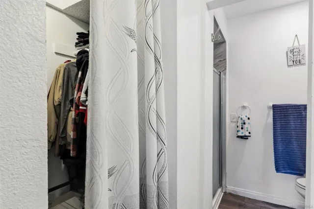 a bathroom with a toilet and a shower curtain