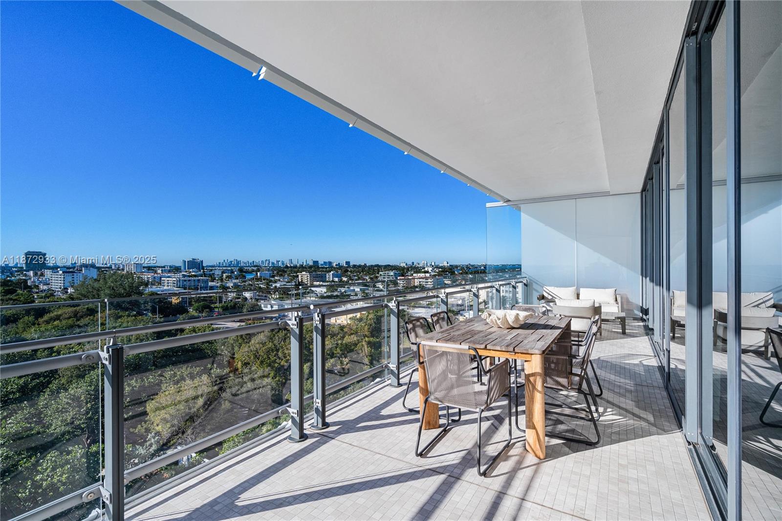8701 Collins Avenue, Unit 804 Miami Beach, FL 33154 - Photo 25 of 25 a view of a chairs and table in a balcony