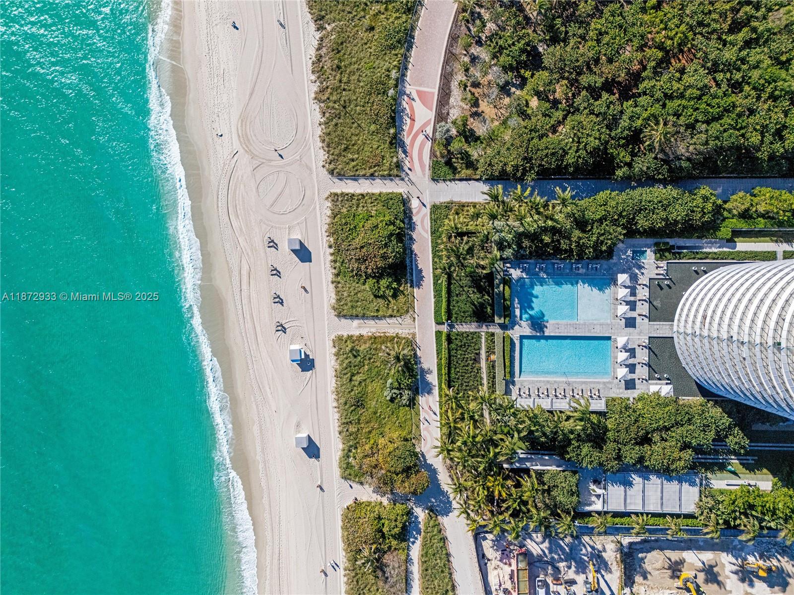 8701 Collins Avenue, Unit 804 Miami Beach, FL 33154 - Photo 7 of 25 front view of a house with a garden
