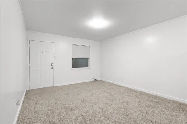 a view of a kitchen with refrigerator and more cabinets