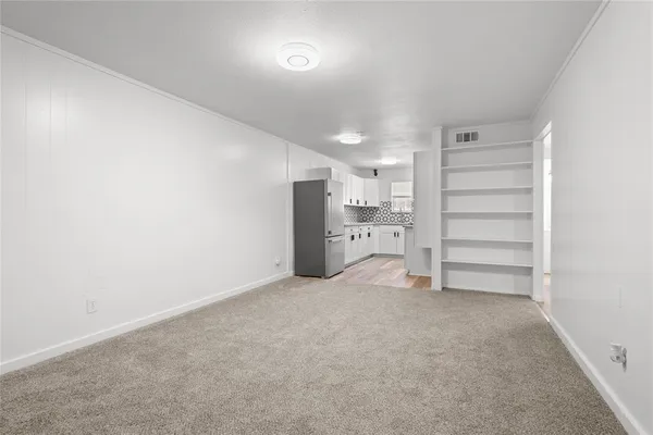 a kitchen with granite countertop cabinets stainless steel appliances a sink and wooden floor