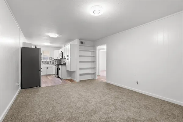 a kitchen with white cabinets and stainless steel appliances