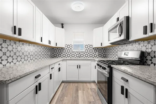a stove top oven sitting inside of a kitchen