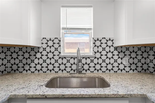 a stove top oven sitting inside of a kitchen