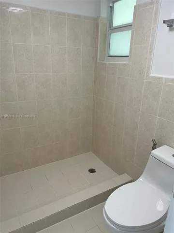 a view of a balcony with wooden floor and fence