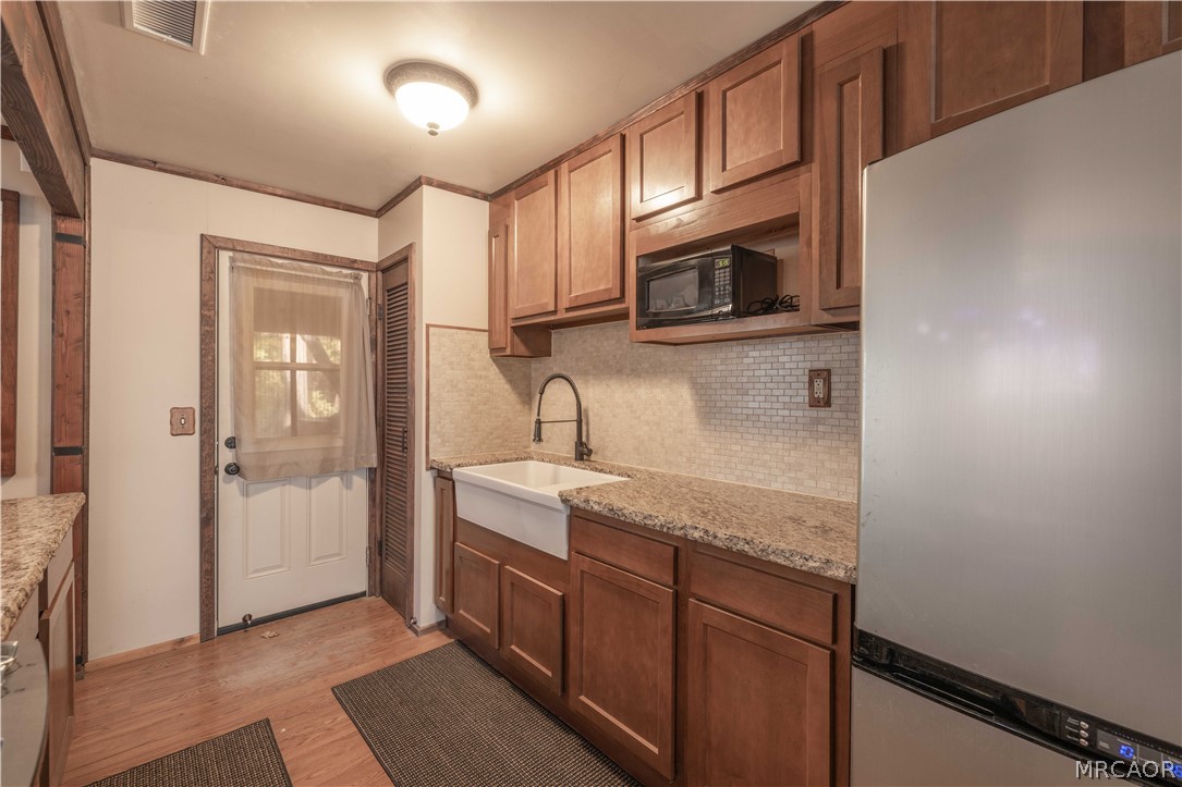 773 Sunset Lane Sugarloaf, CA 92386 - Photo 7 of 33 a kitchen with stainless steel appliances granite countertop a sink and a microwave