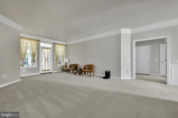 a view of a livingroom with furniture and a window