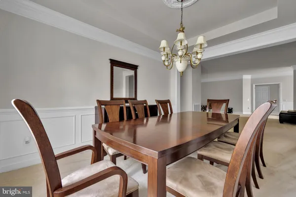 a view of a dining room with furniture and a chandelier