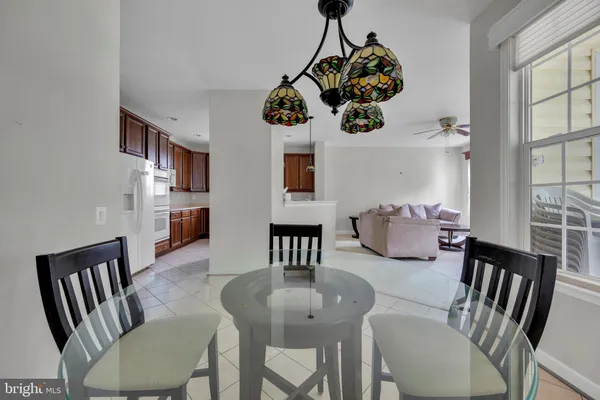 a view of a dining room with furniture a livingroom and chandelier