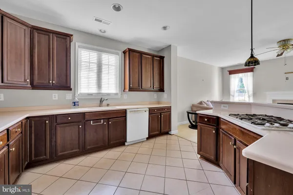 a kitchen with a stove sink and cabinets