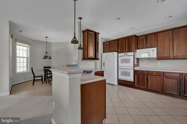 a kitchen with refrigerator cabinets and wooden floor