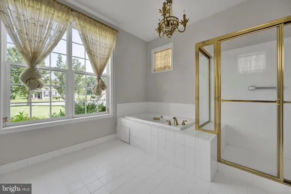 a spacious bathroom with a bathtub and a shower