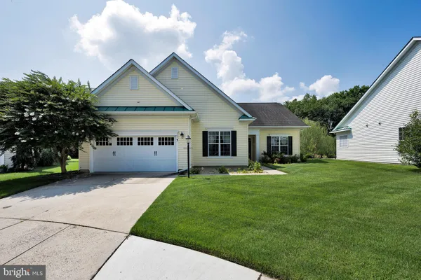 a front view of a house with a garden and porch