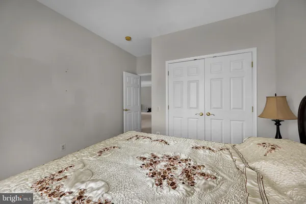 a bedroom with a bed and a lamp