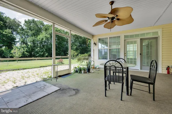 a dining room with furniture and a floor to ceiling window