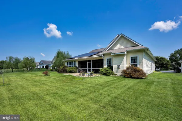 a view of a house with a yard and sitting area
