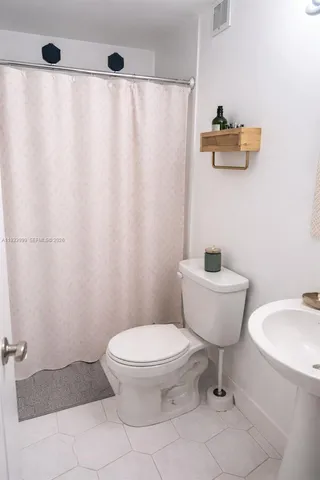 a bathroom with a toilet and a sink