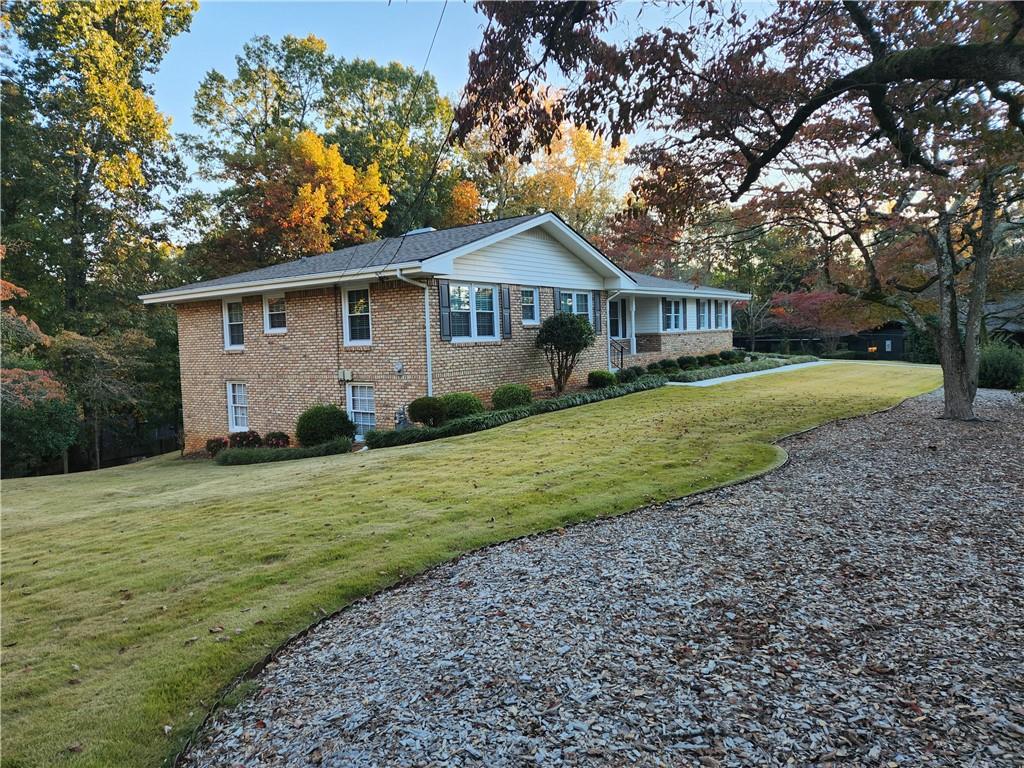 1554 Cooper Lake Road Southeast Smyrna, GA 30082 - Photo 3 of 49 a front view of a house with a garden