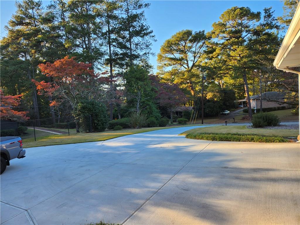 1554 Cooper Lake Road Southeast Smyrna, GA 30082 - Photo 6 of 49 a view of pool and trees in the background