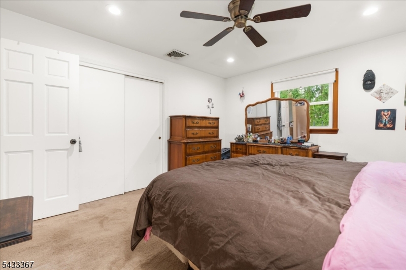 650 Woodglen Road Glen Gardner, NJ 08826 - Photo 17 of 28 a bed room with a bed and a dresser