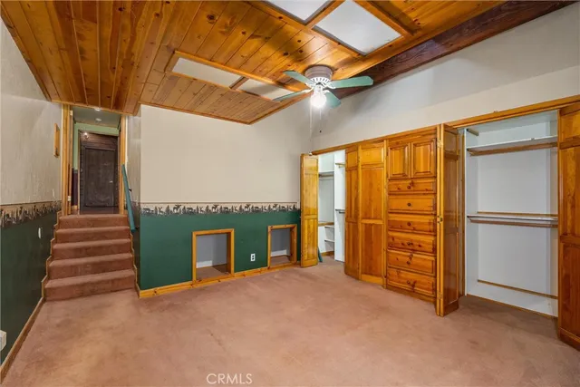 a bedroom with a bed and a night stand