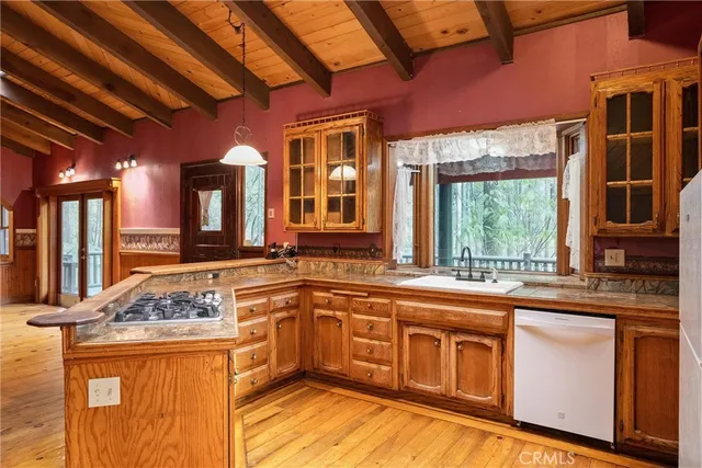 a view of a kitchen with a sink and cabinets