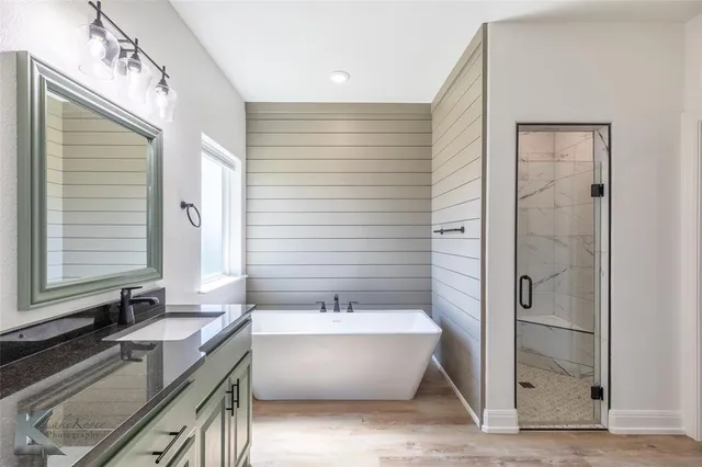 a bathroom with a bathtub and a sink